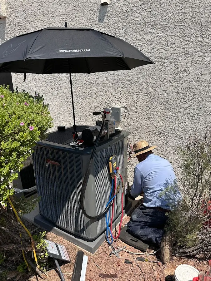 HVAC technician performing outdoor AC maintenance in Vacaville
